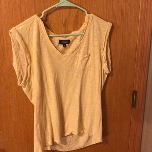 yellow short sleeved top with a chest pocket